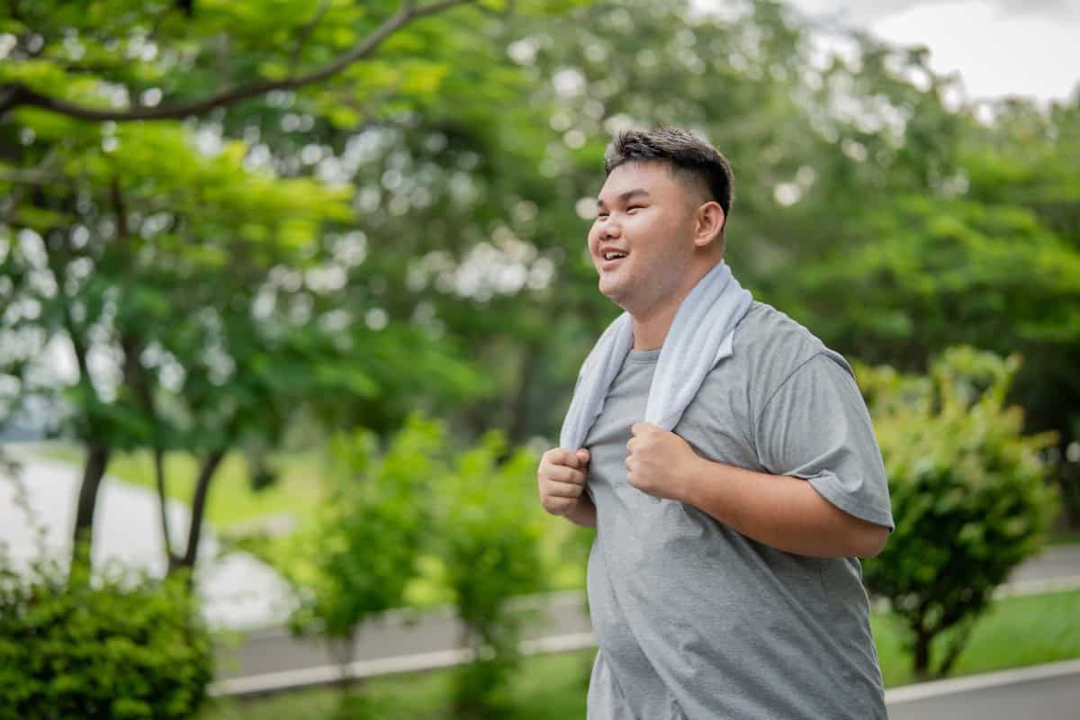 Man resting outdoors with a towel after exercise