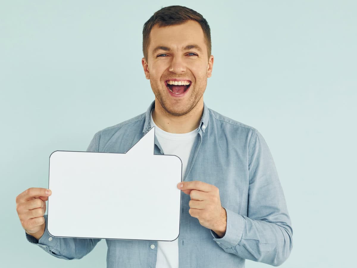 in casual clothes. man standing in the studio with empty signs for the text