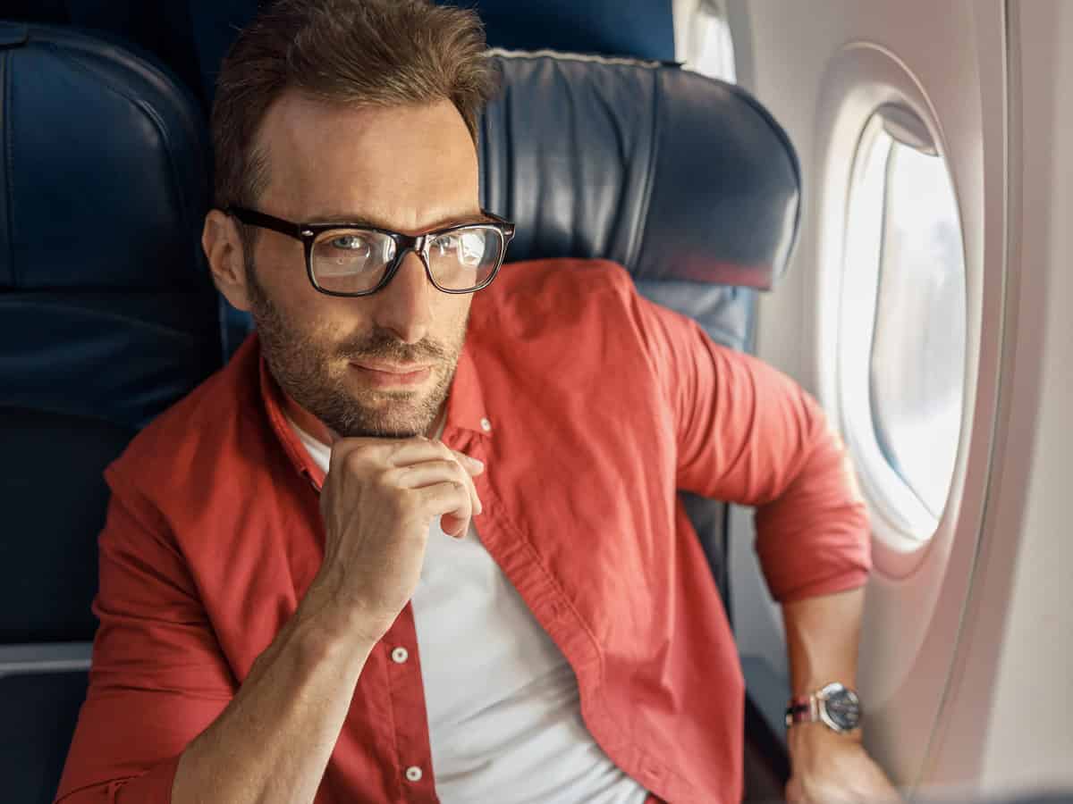 attractive caucasian businessman in casual wear and glasses looking thoughtful