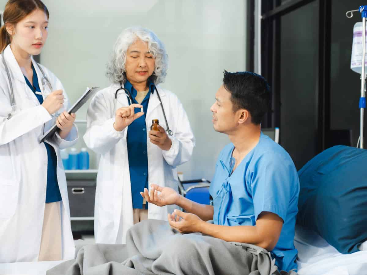 medicine, healthcare and people concept doctor talking to male