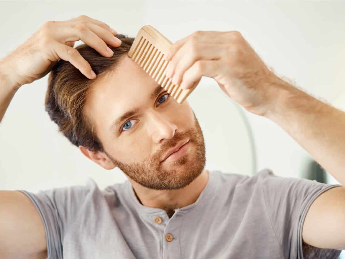 Master Hair Transplant Aftercare to Protect Your Results one handsome man combing his hair in a bathroom at 2026 01 09 09 54 40 utc 1920x1355