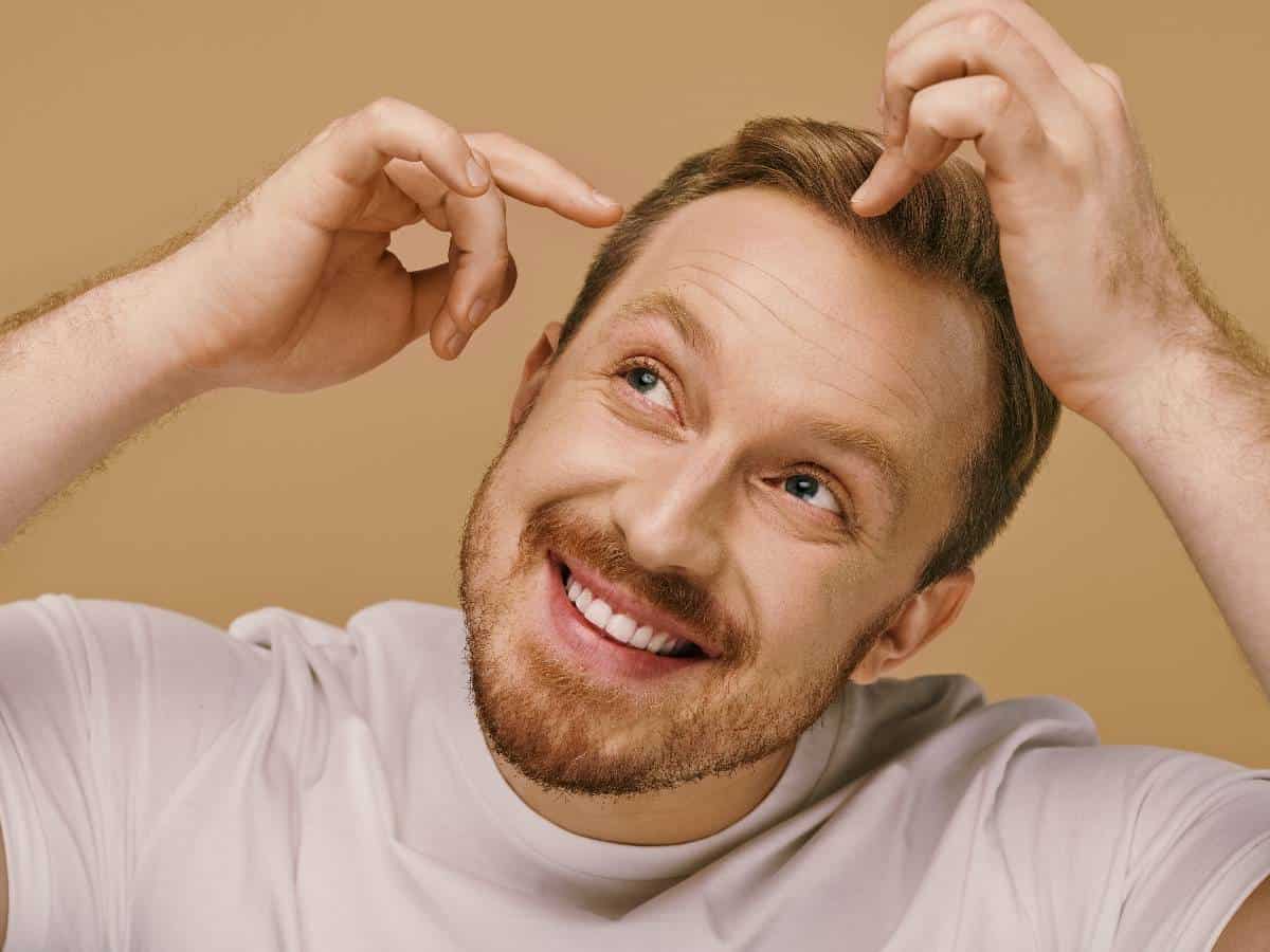 smiling goateed man with stylish hair pose 2026 01 09 12 21 15 utc
