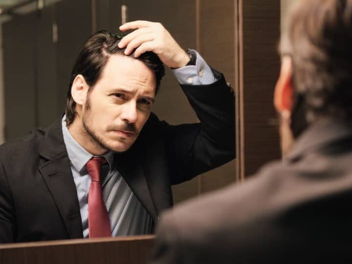 worried business man looking at hairline 2026 03 17 00 49 30 utc