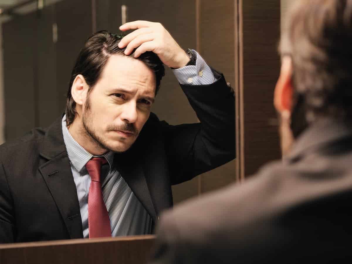 worried business man looking at hairline 2026 03 17 00 49 30 utc