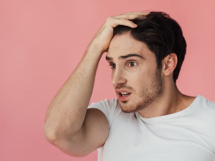 worried man with hand on head on pink 2026 03 25 10 13 11 utc (1)
