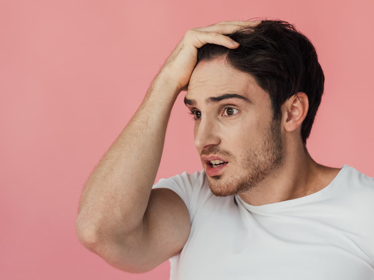 worried man with hand on head on pink 2026 03 25 10 13 11 utc (1)