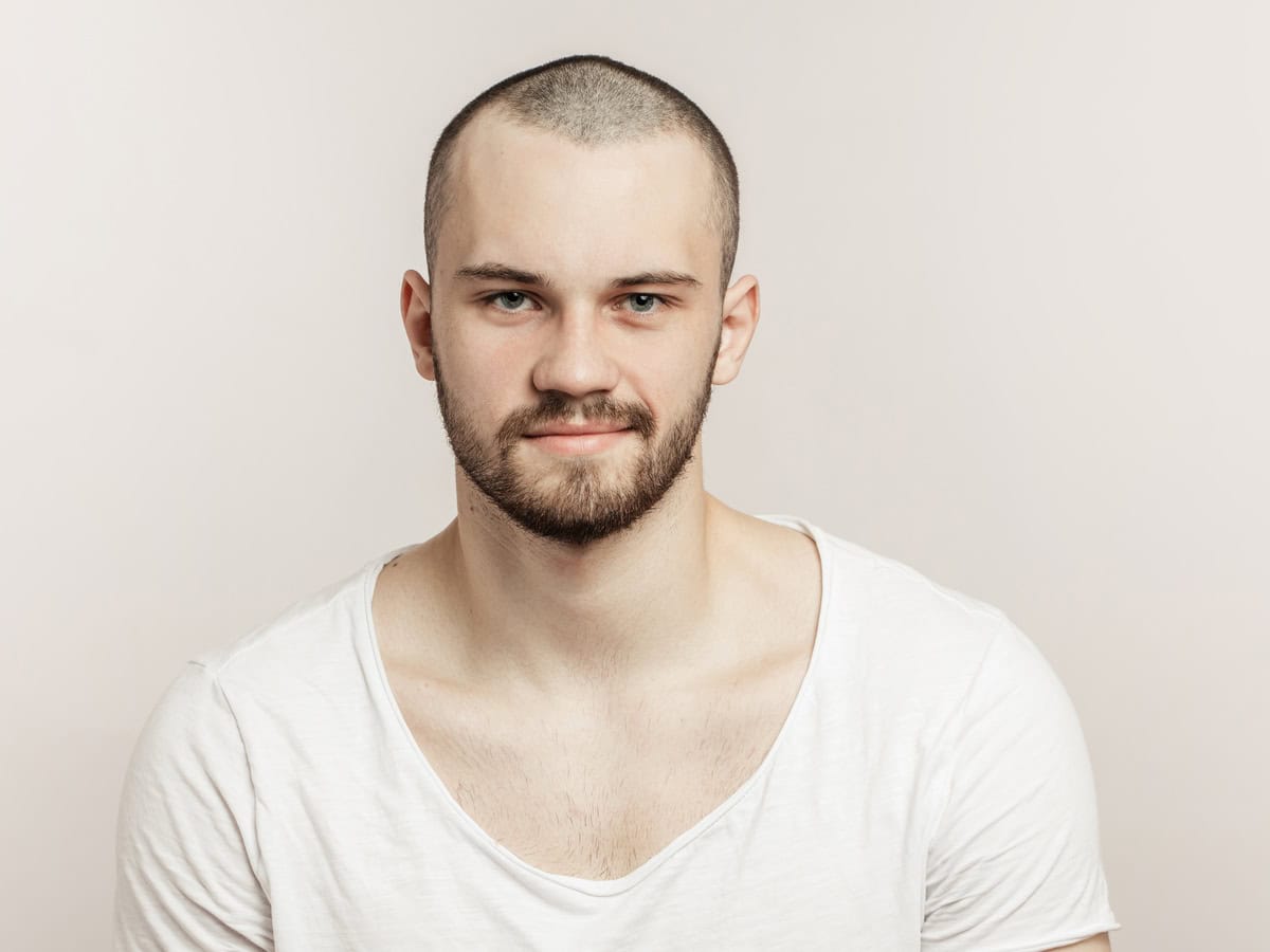 young man in white t shirt posing indoors 2026 03 25 23 40 54 utc